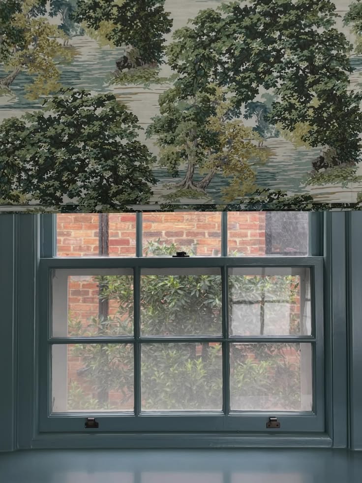 Patterned roman blind in a kitchen with woven bamboo layered beneath