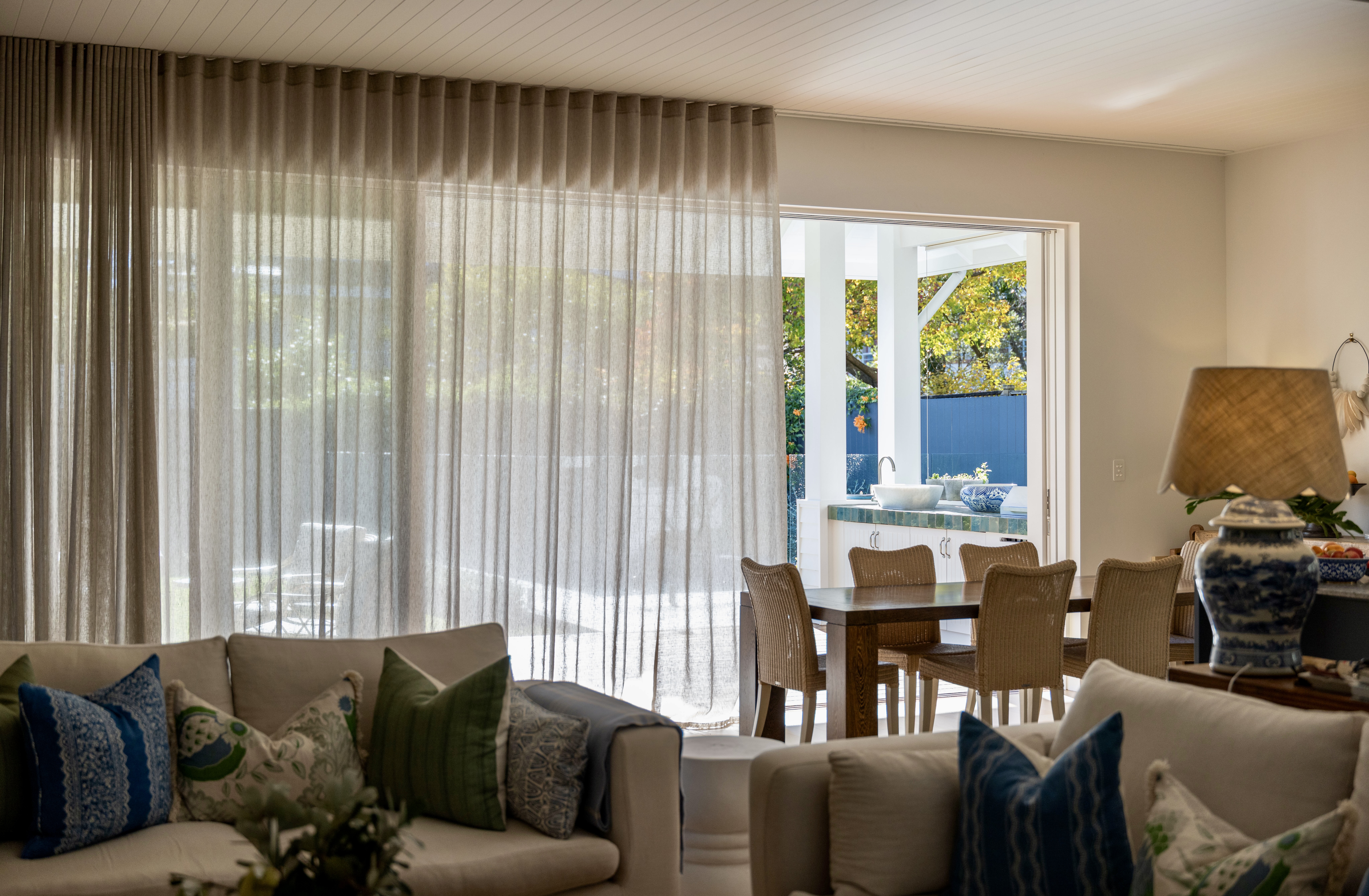 Floor-to-ceiling sheer curtains in a Mosman dining room by The Style Workshop