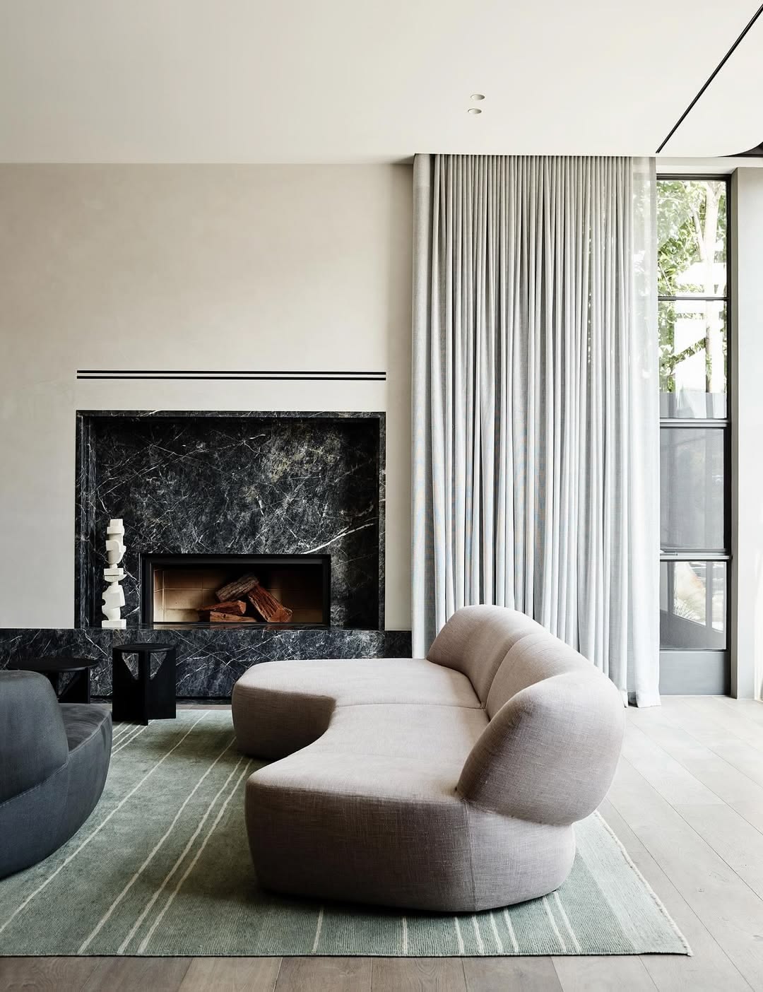 Floor-to-ceiling curtains in a considered living room