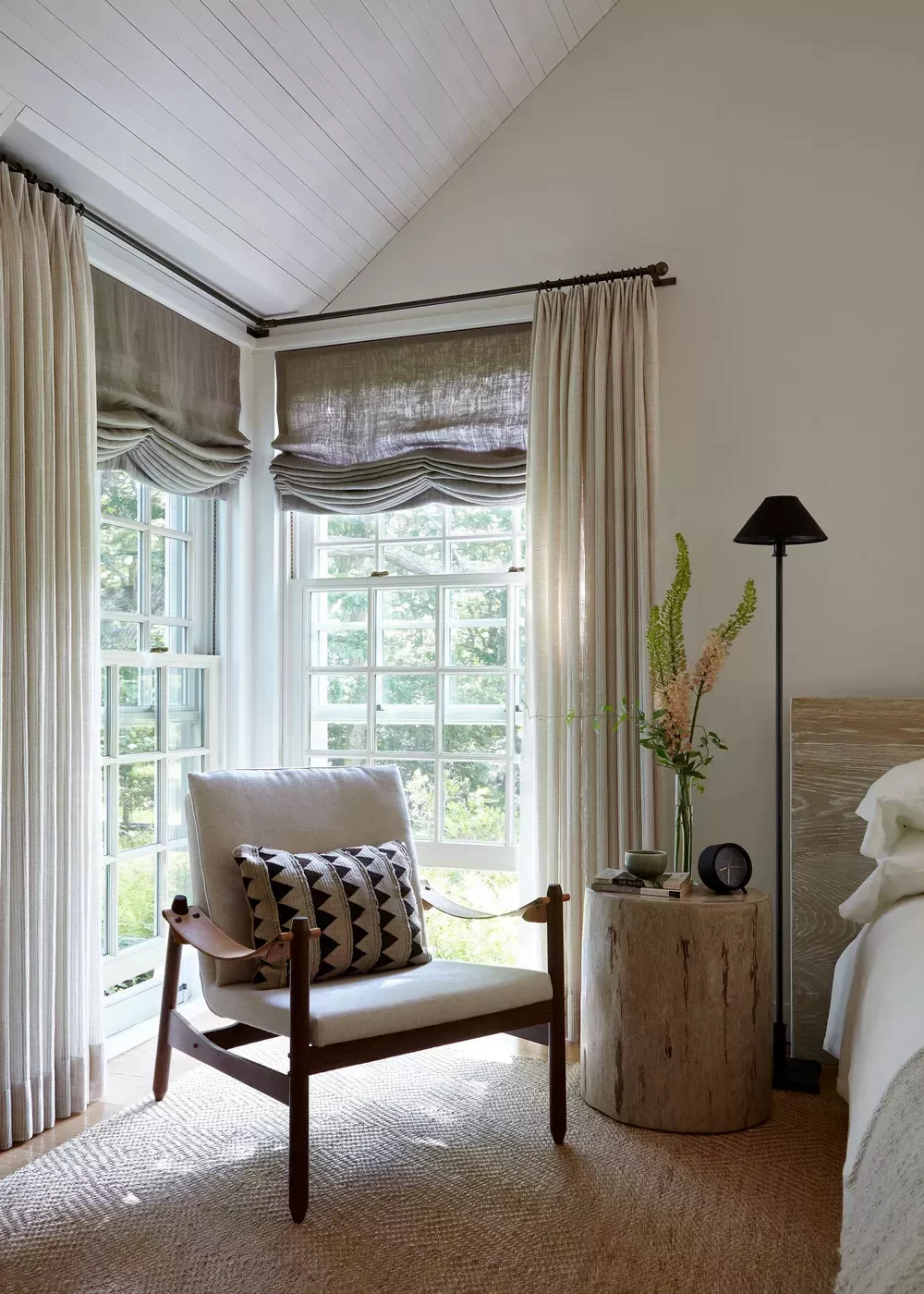 A layered window treatment — roman blind with sheer curtain in front