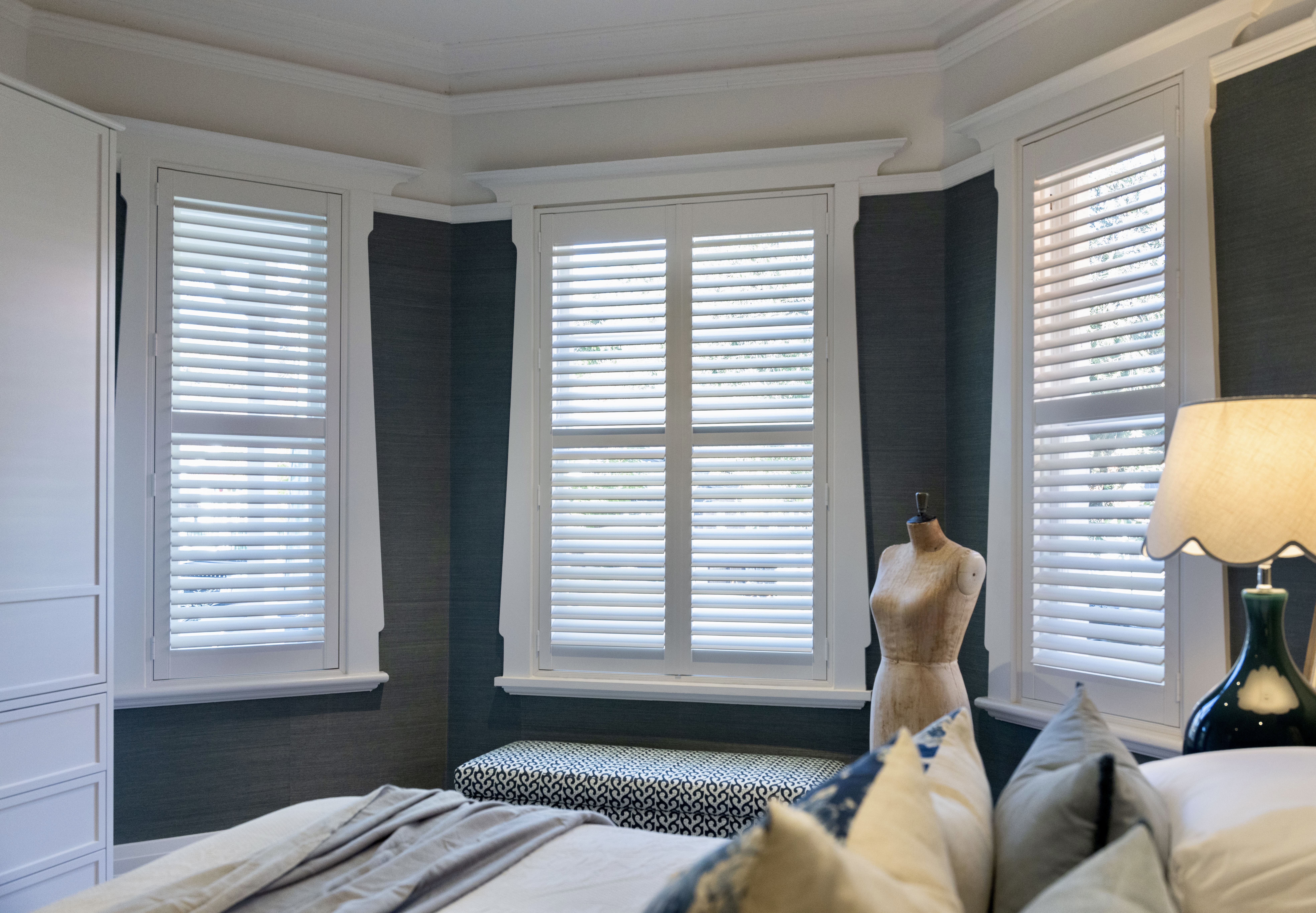 White plantation shutters in a Mosman bay window bedroom