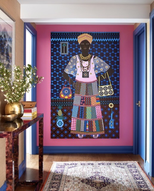 Large colourful figurative painting by Carla Kranendonk on a pink wall in an entry hall, The Style Workshop