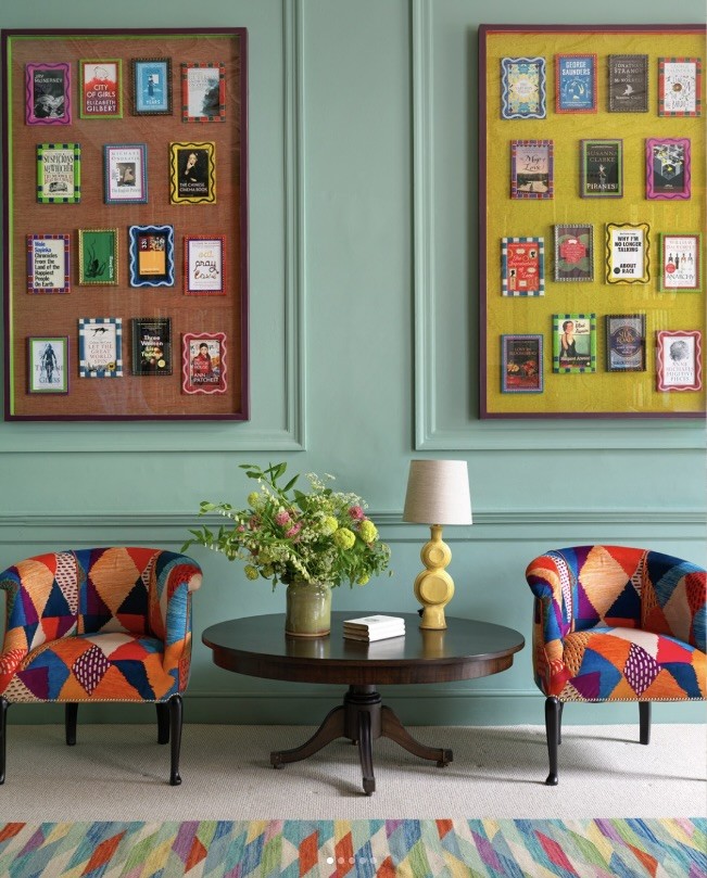 Framed collections of book covers in coloured frames on a panelled mint wall, The Style Workshop