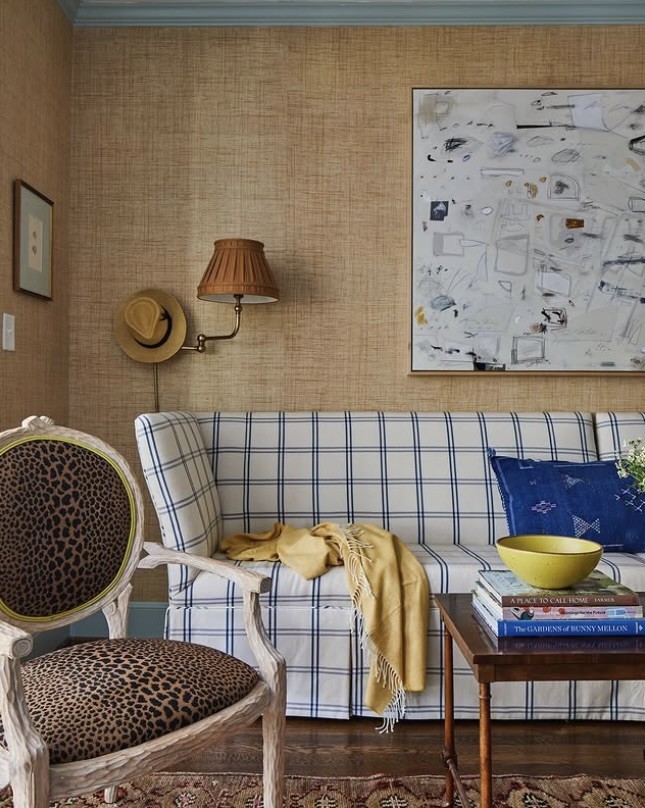 Large abstract artwork above a checked sofa on a grasscloth wall, The Style Workshop