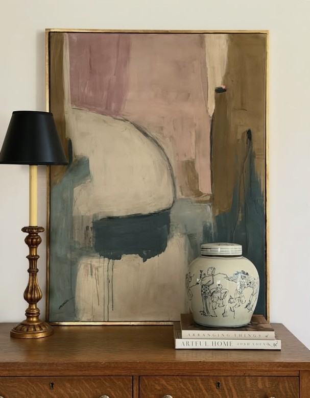 Abstract canvas leaning against the wall on a timber chest with a lamp and ginger jar, The Style Workshop