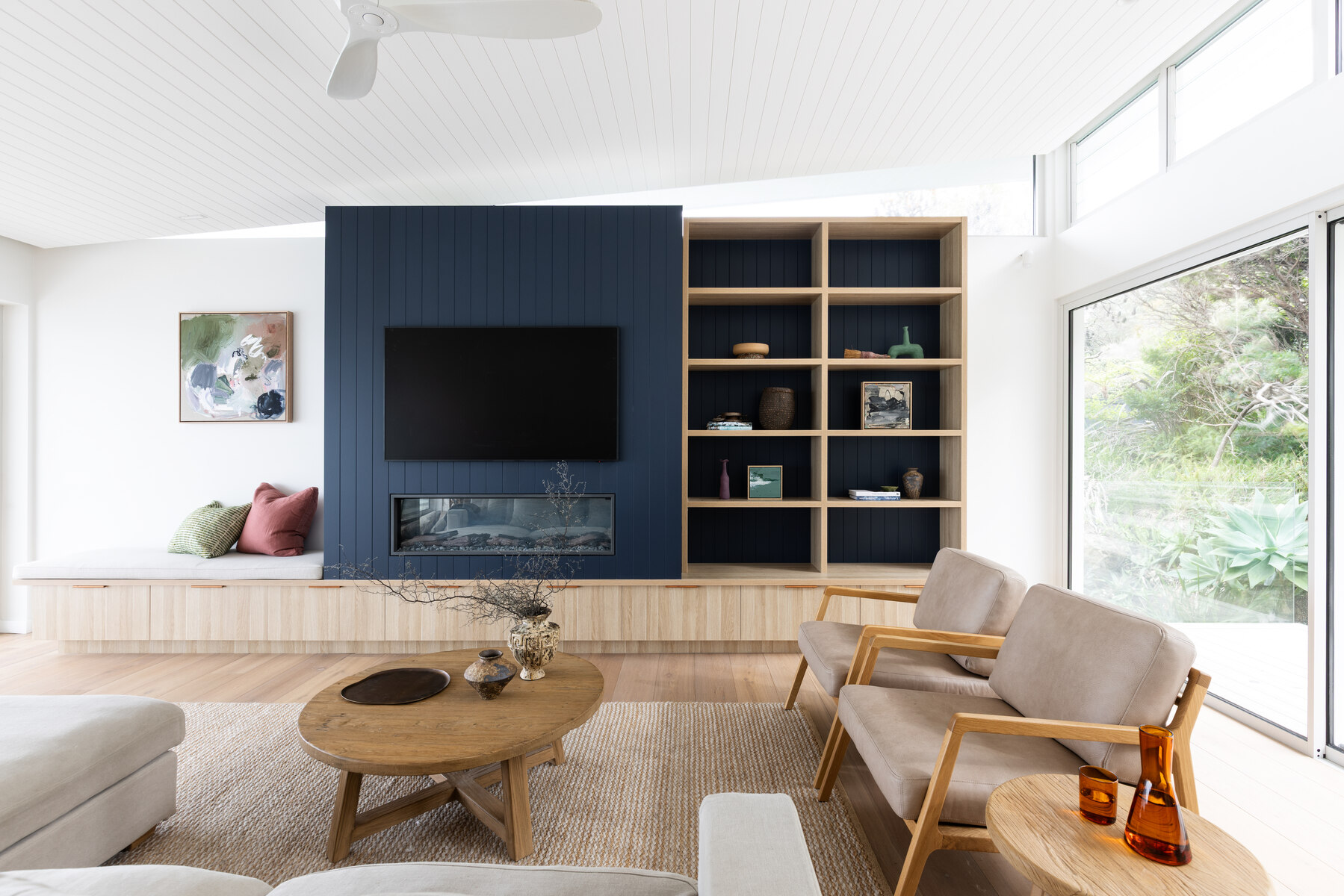 Whale Beach House living room with navy joinery and warm neutral palette, The Style Workshop