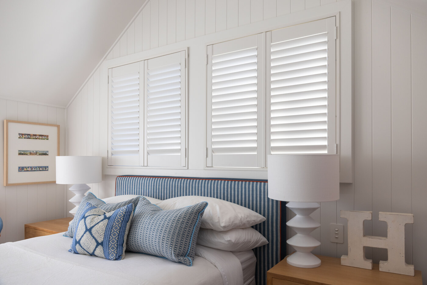 Mosman bedroom with white plantation shutters and blue striped headboard, The Style Workshop