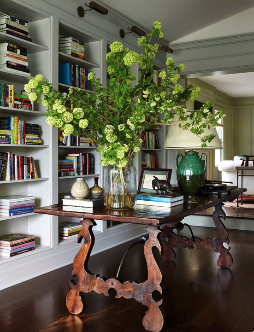 Antique console table styled with a large vase of green viburnum branches, The Style Workshop