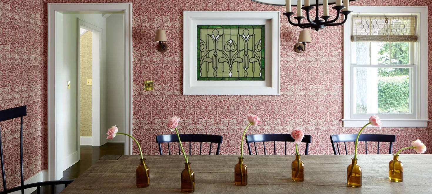 Spring dining table styled with single-stem bud vases against patterned wallpaper, The Style Workshop
