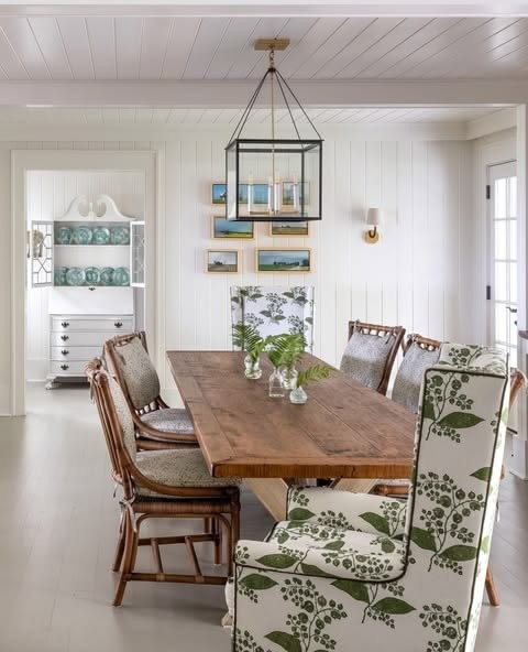 Coastal dining room with rattan chairs and leaf-print upholstery, The Style Workshop