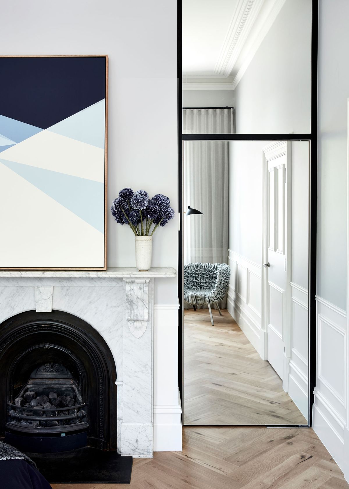 Original marble fireplace with contemporary steel-framed mirror door, North Shore home, The Style Workshop