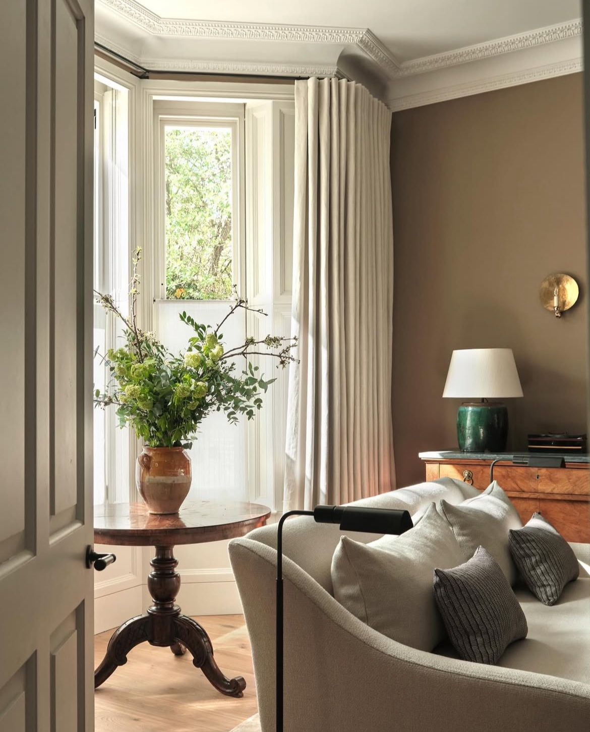 Layered sheer and heavy curtains hung floor to ceiling in a North Shore bay window, The Style Workshop