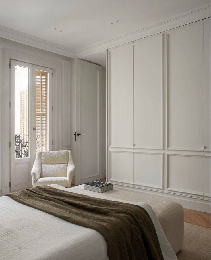 Light-filled contemporary bedroom addition with built-in joinery and French doors
