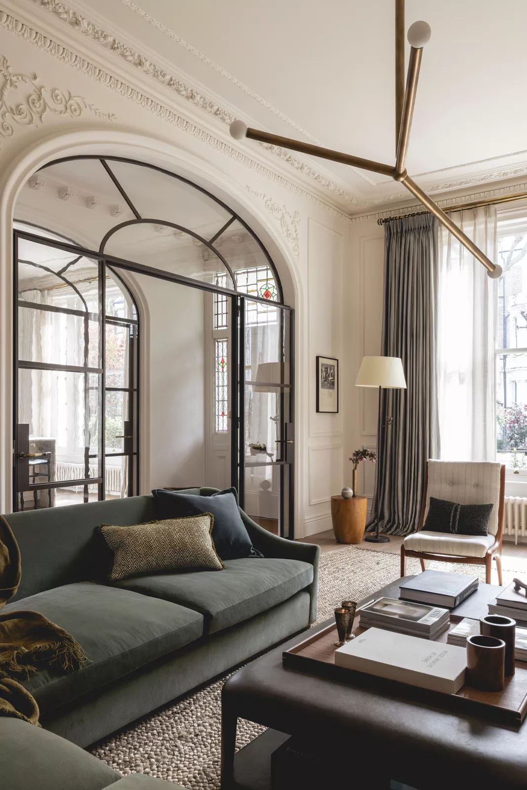 Ornate plaster cornice above a steel-framed glazed archway
