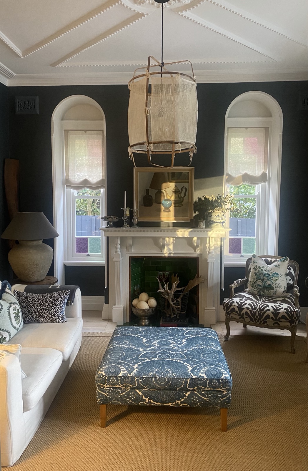 The same Federation sitting room after renovation, with dark grasscloth wallpaper and an eclectic mix of furnishings