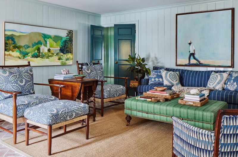 Antique drop-leaf side table between two upholstered armchairs