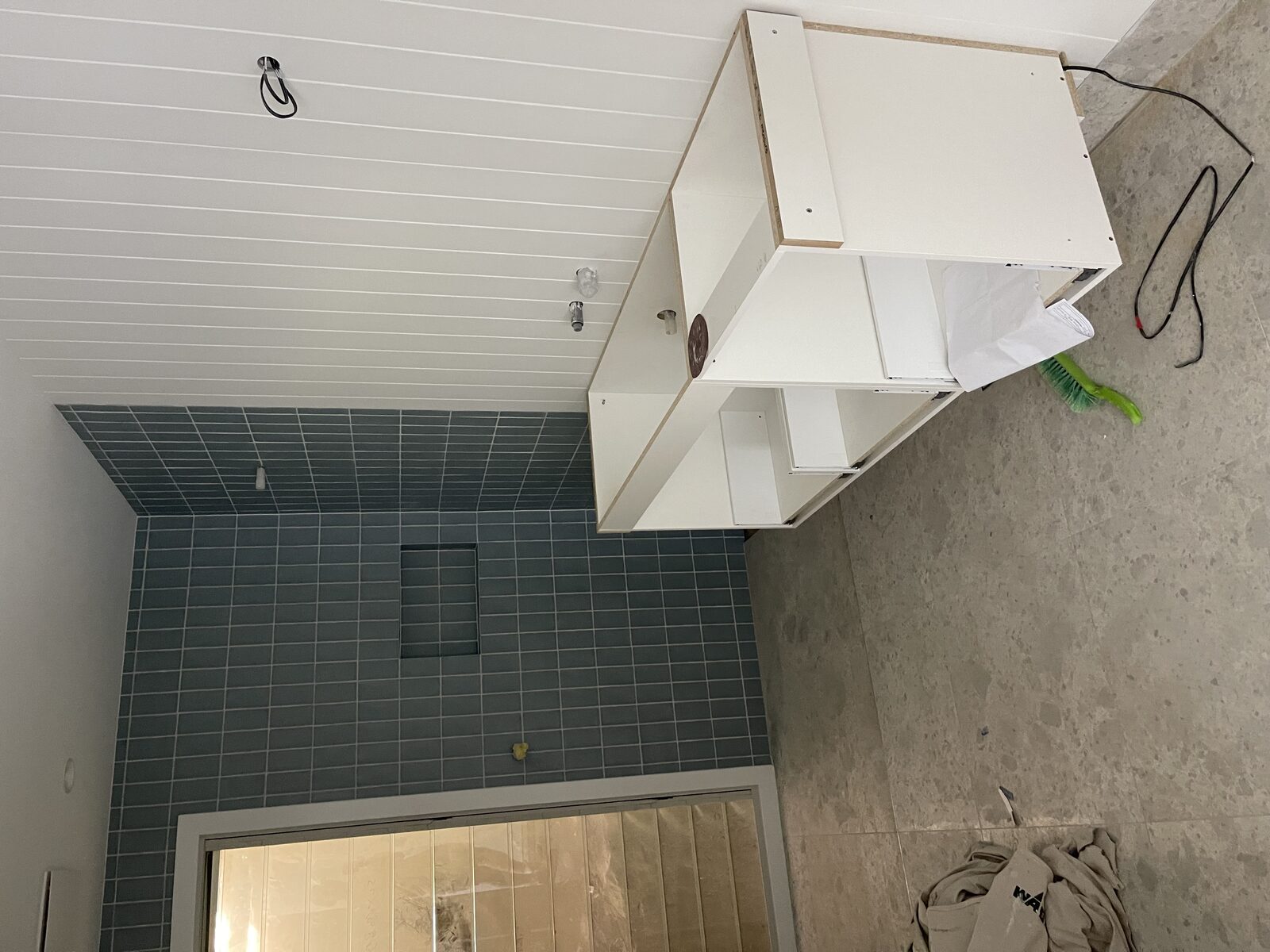 Bathroom mid-construction at the Whale Beach project, vanity carcass and tiling in progress