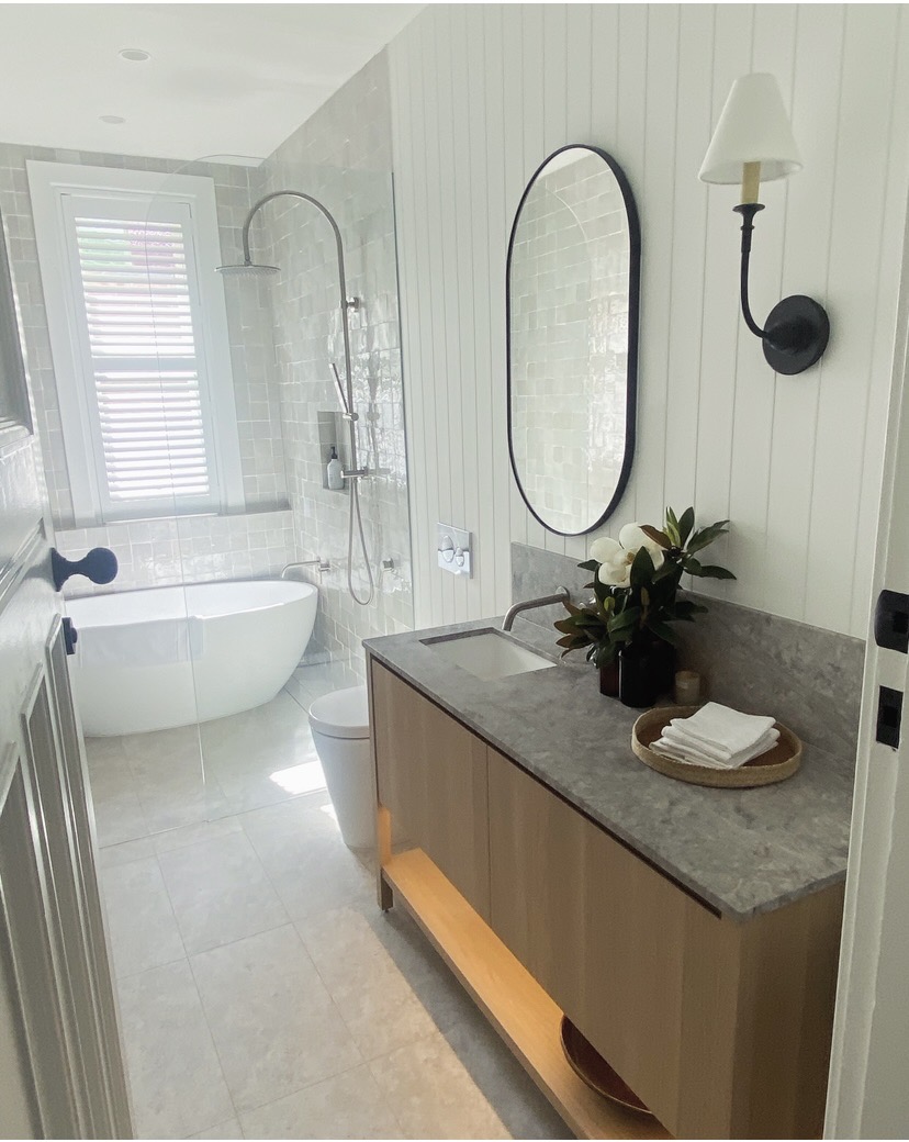 Finished bathroom vanity with stone benchtop and oval mirror, The Style Workshop