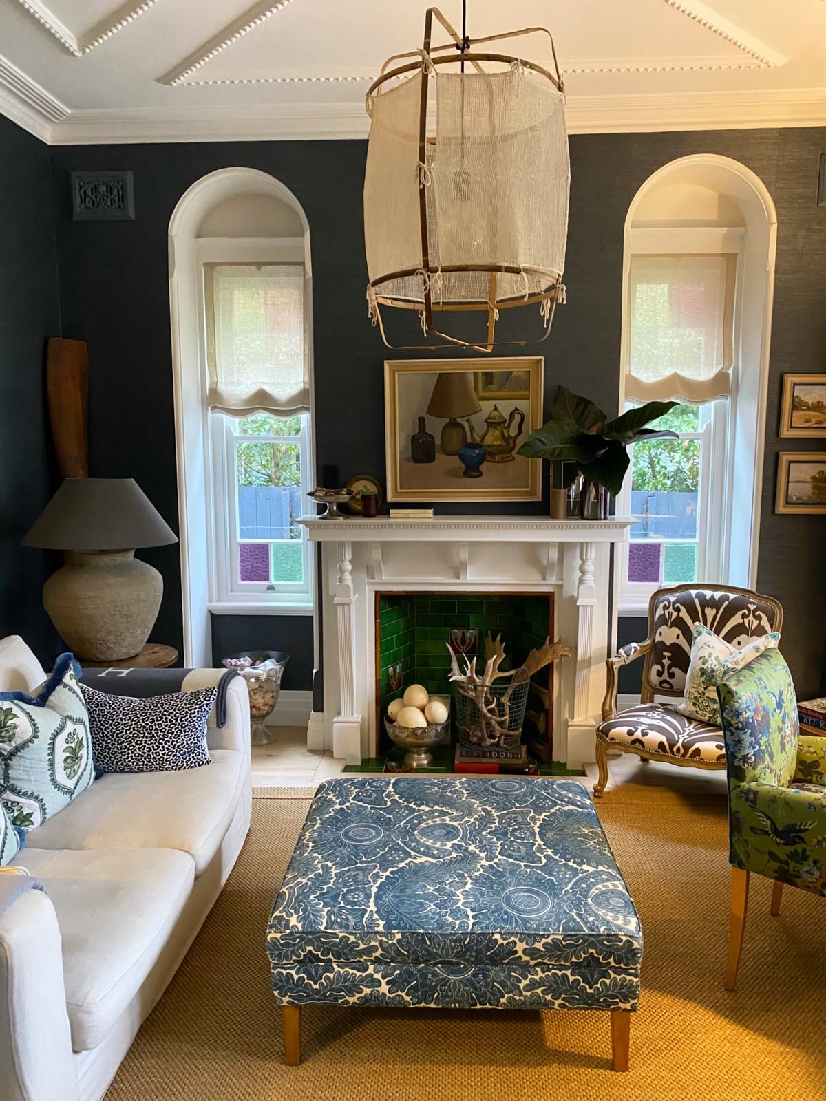 Sitting room in a Mosman Federation home with a woven pendant, table lamp and fireplace framed by arched windows, The Style Workshop