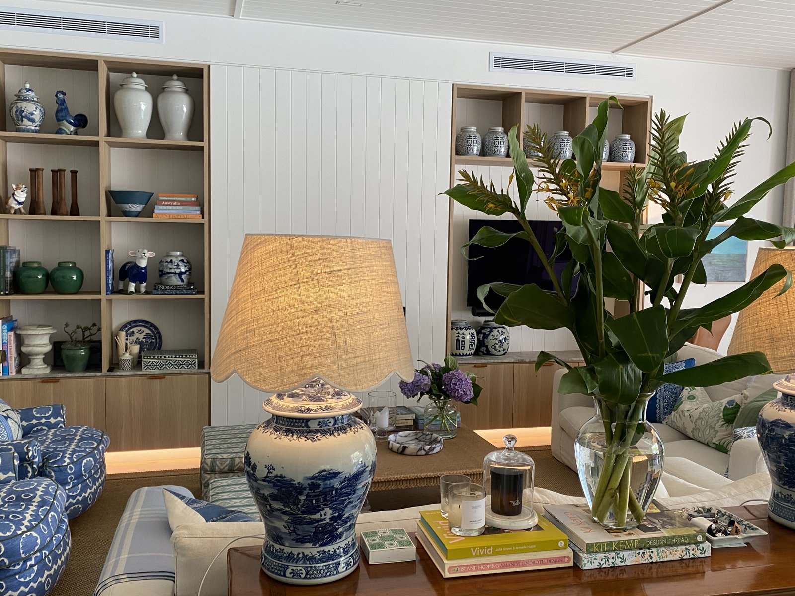 Mosman living room with a blue and white ginger jar lamp, linen shade and lit joinery shelving, The Style Workshop