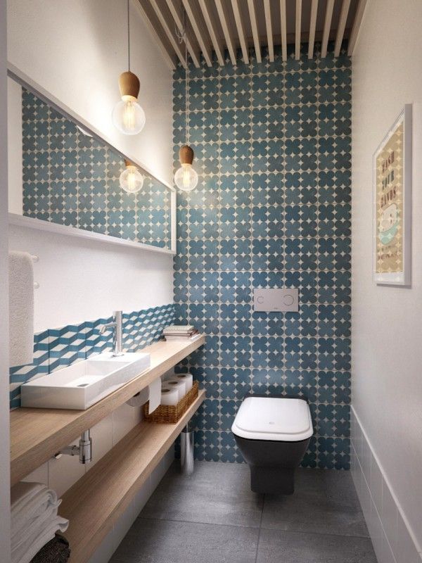 Blue and white geometric tiled powder room floor to ceiling