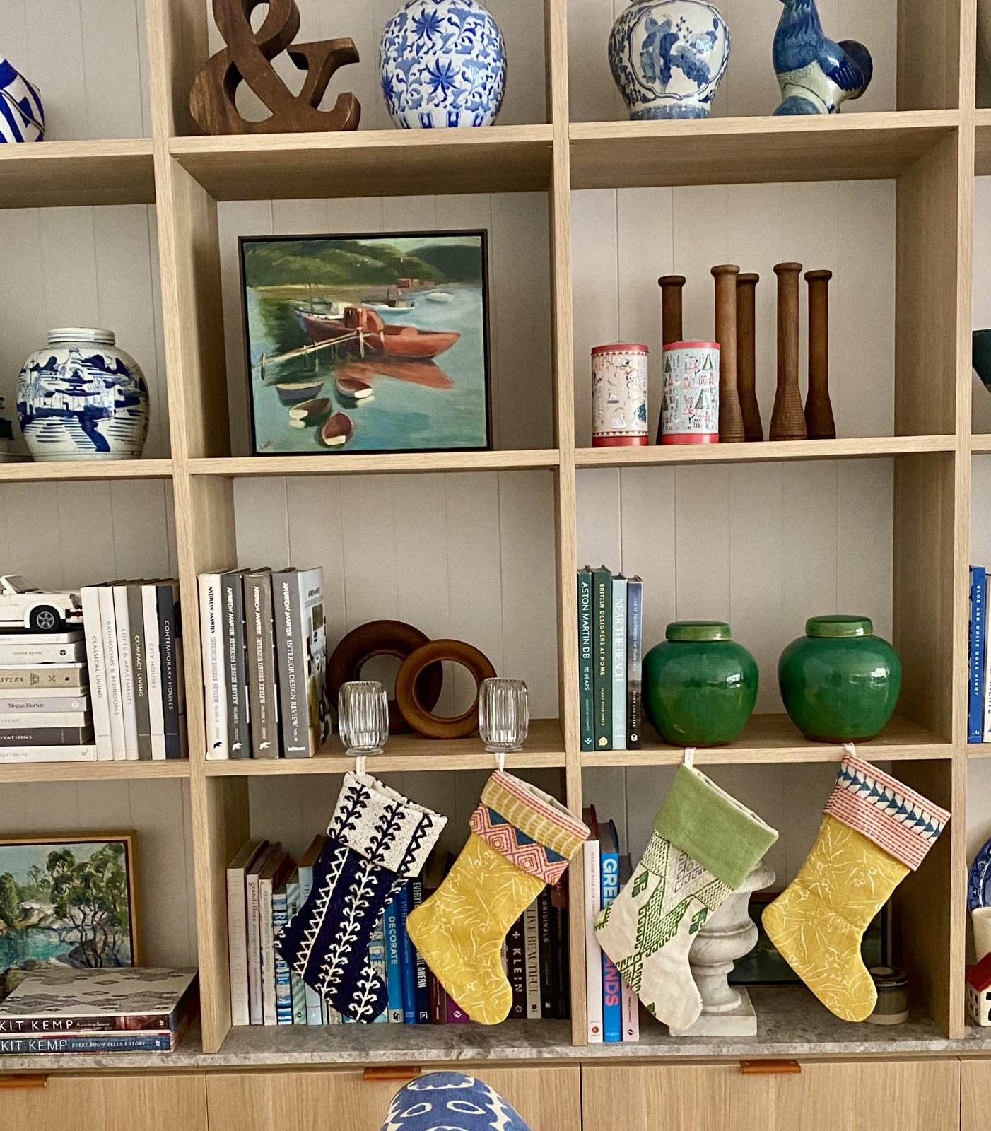 Mosman living room joinery styled with blue and white ceramics, artwork, books and Christmas stockings, The Style Workshop