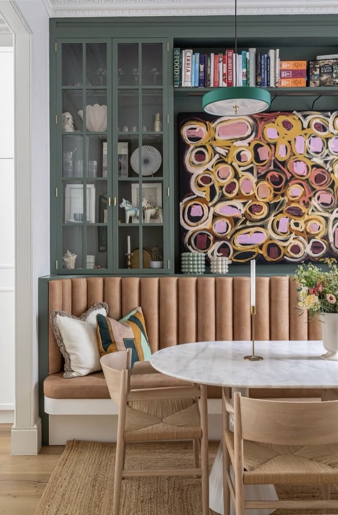 Dining nook with a built-in banquette and a round marble table, The Style Workshop