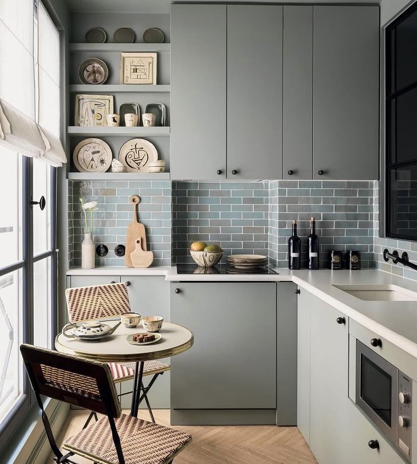 Small galley kitchen with a bistro table and chairs doing double duty as a breakfast nook, The Style Workshop