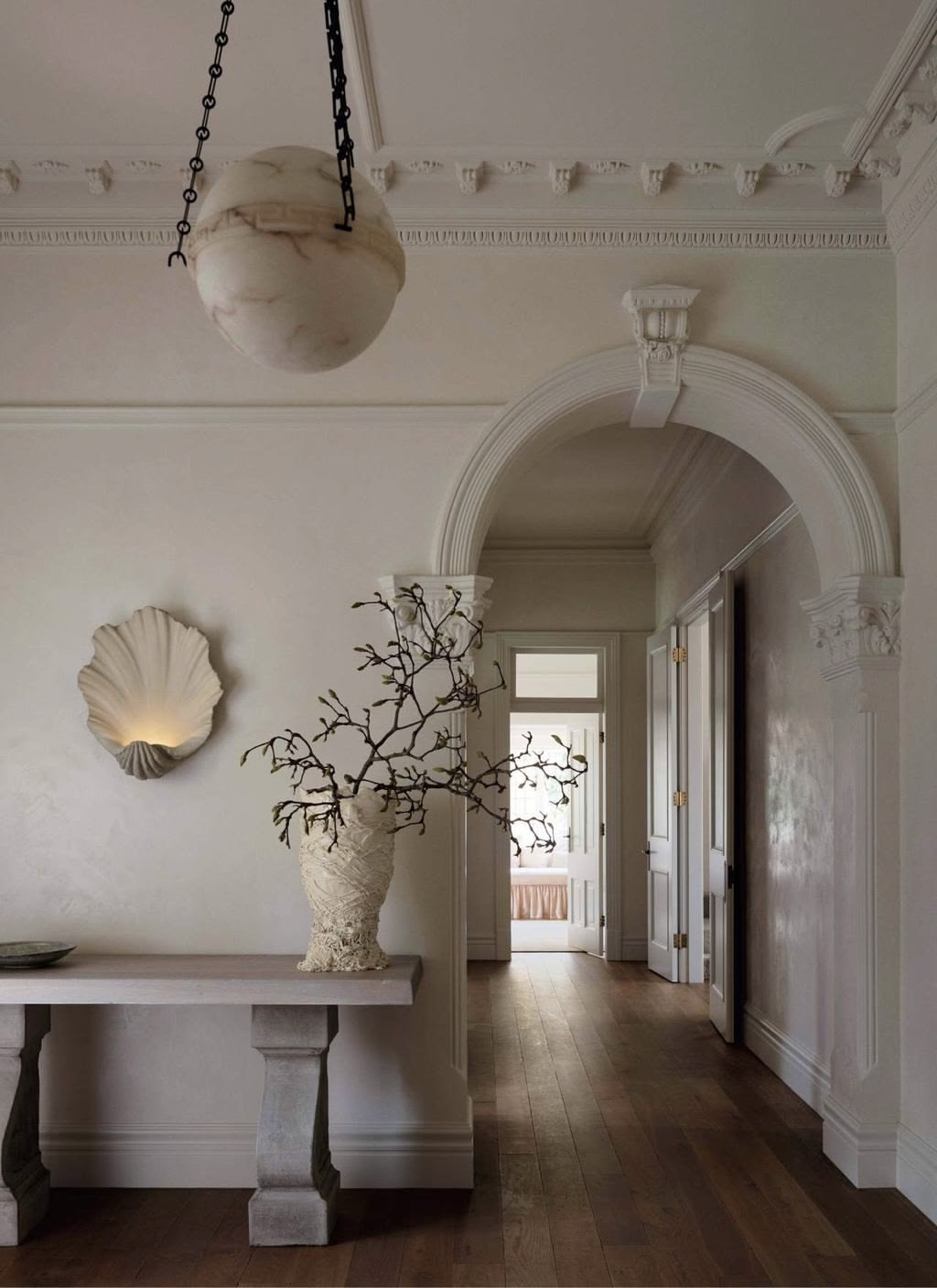 Federation interior hallway showing ornate plaster cornice, decorative arch and timber floors