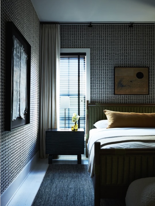 Bedroom with bold patterned wallpaper and a deep green channel-tufted bed frame, The Style Workshop