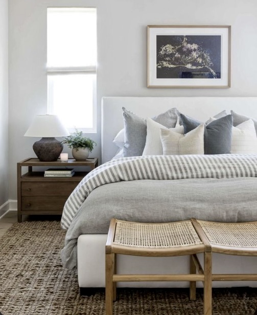 A generously sized natural fibre rug extending well beyond the sides and foot of the bed, The Style Workshop