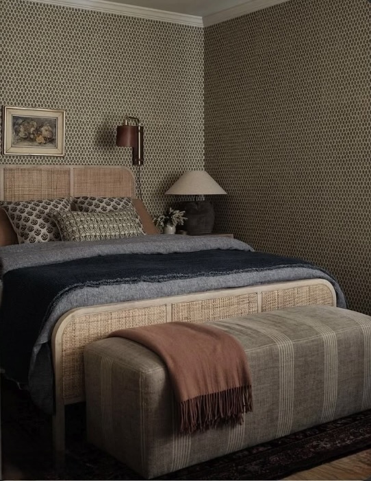 Warm bedside lamp and wall sconce layered together against patterned wallpaper, The Style Workshop