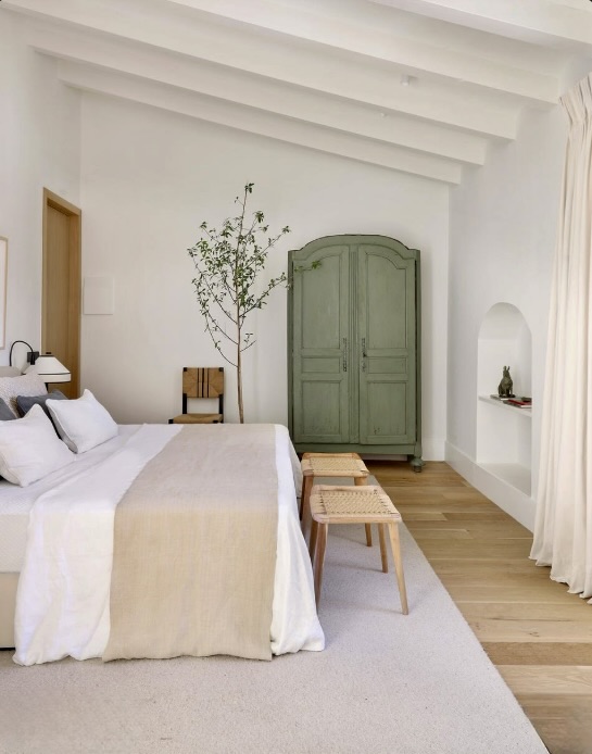 Tall green painted armoire and an indoor tree bringing the eye up to a beamed ceiling, The Style Workshop